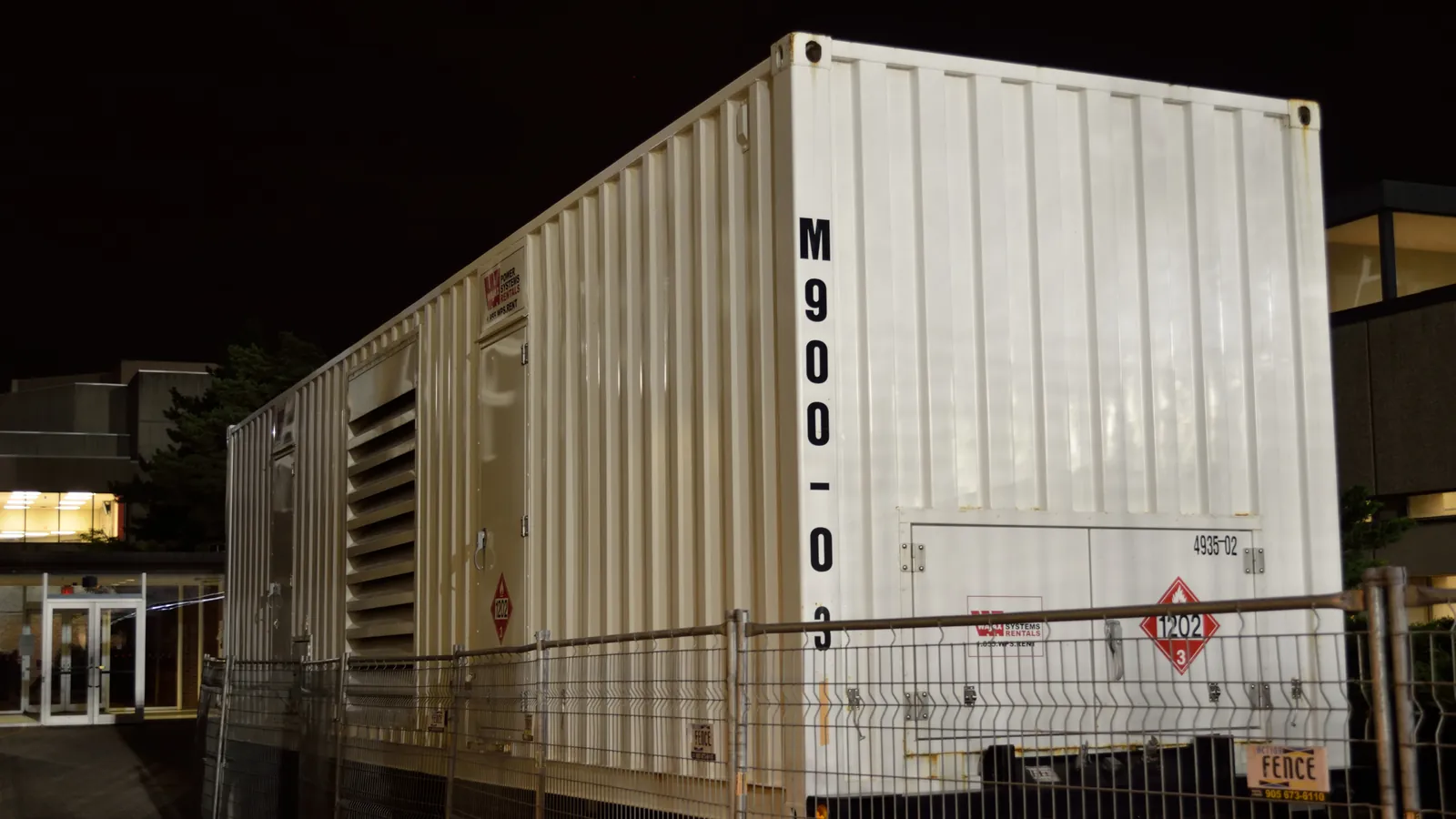Containerised equipment shelter at a site at night